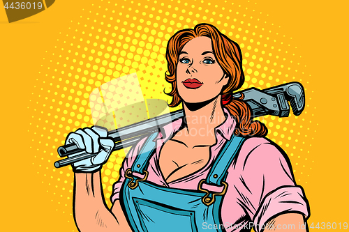 Image of A strong woman mechanic plumber worker with adjustable wrench