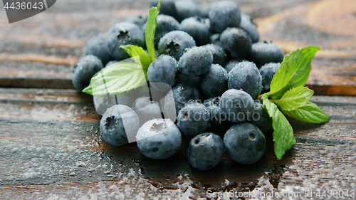 Image of Fresh blueberry and green leaf on table 