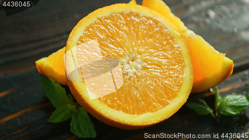 Image of Sliced orange with green leaves 