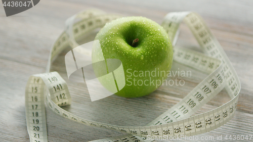 Image of Green apple and tape measure 