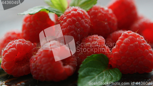 Image of Ripe appetizing raspberry with leaves 