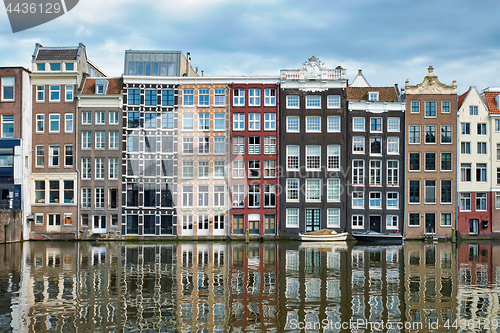 Image of Amsterdam canal Damrak with houses, Netherlands