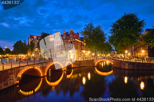 Image of Amterdam canal, bridge and medieval houses in the evening