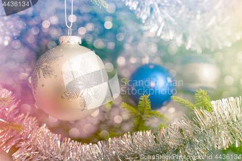 Image of Christmas-tree decoration bauble on decorated Christmas tree bac