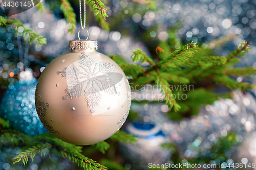 Image of Christmas-tree decoration bauble on decorated Christmas tree bac