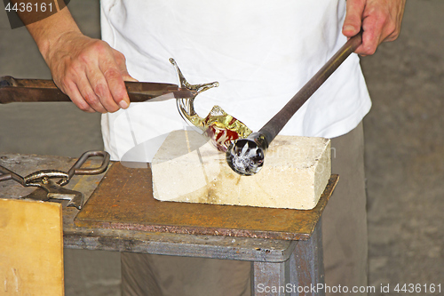 Image of Glass worker makes glass sculptures in glass factory in Murano, 