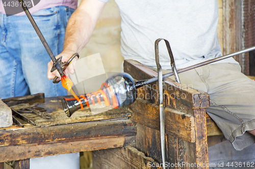 Image of Glass worker makes glass sculptures in glass factory in Murano, 