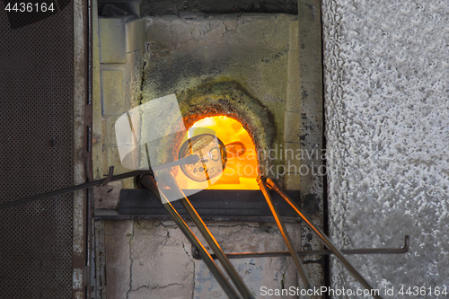 Image of Manufacturing glass in a traditional oven, in glass factory in M
