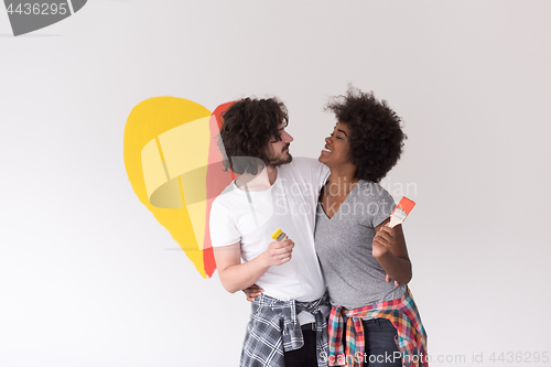 Image of couple with painted heart on wall