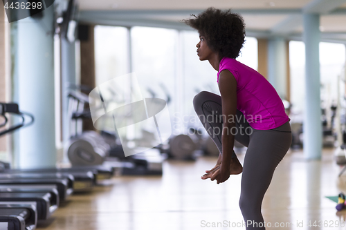 Image of african american woman exercise yoga in gym