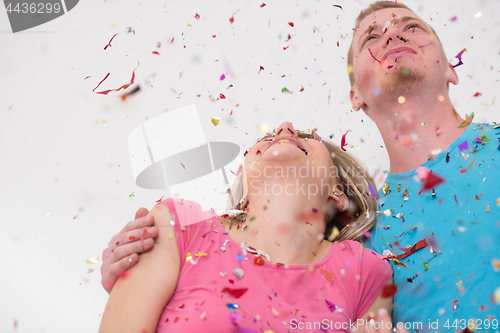 Image of romantic young  couple celebrating  party with confetti