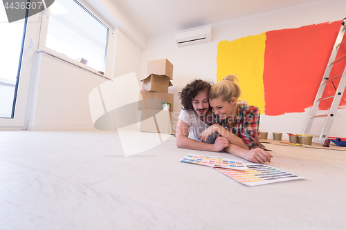 Image of Happy young couple relaxing after painting