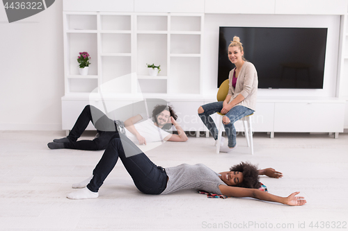Image of multiethnic group of people relax in their new apartment