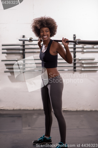 Image of black woman lifting empty bar