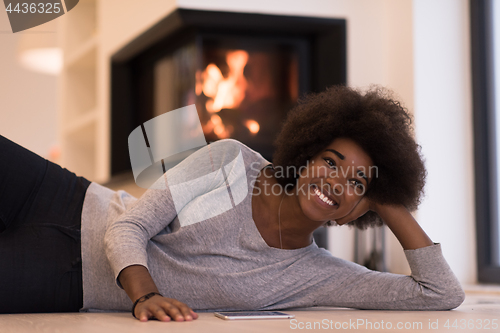 Image of black women using tablet computer on the floor