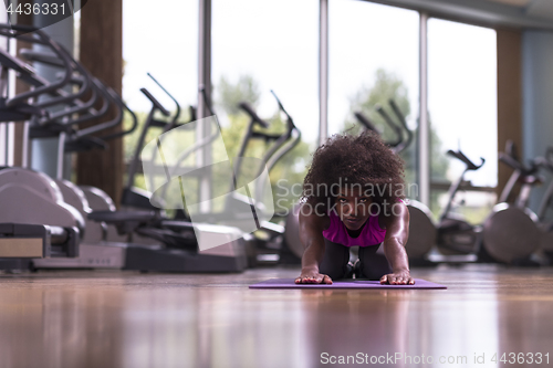 Image of african american woman exercise yoga in gym