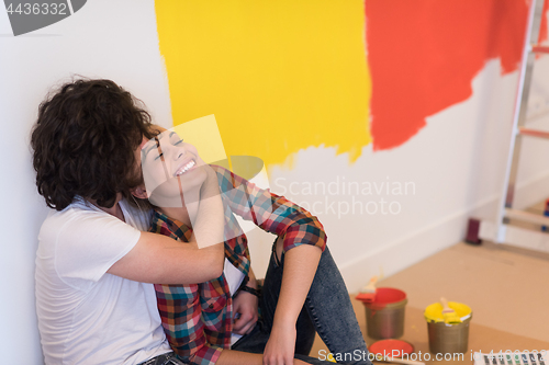 Image of Happy young couple relaxing after painting