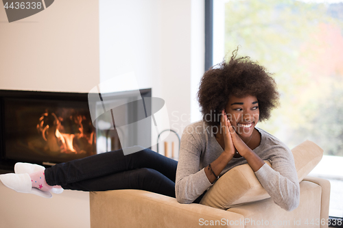 Image of black woman in front of fireplace