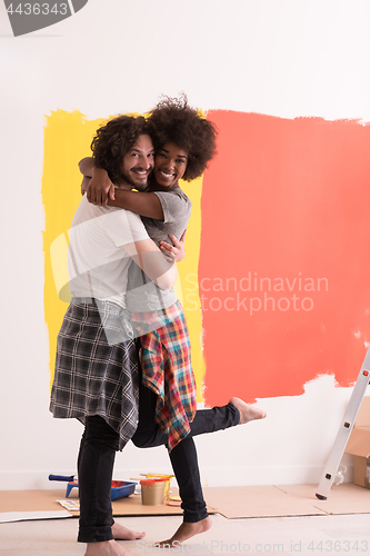 Image of Young happy multiethnic couple hugging