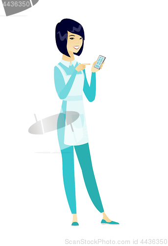 Image of Asian cleaner holding a mobile phone.