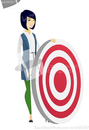 Image of Young business woman and dart board.