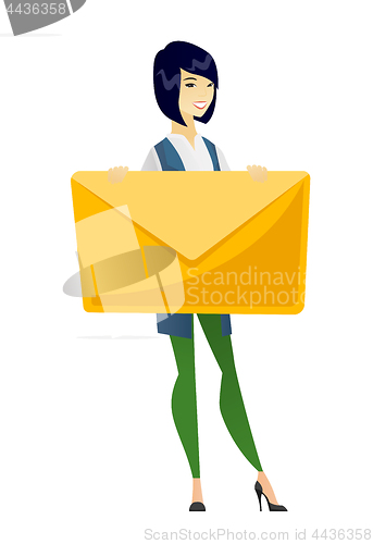 Image of Smiling business woman holding a big envelope.