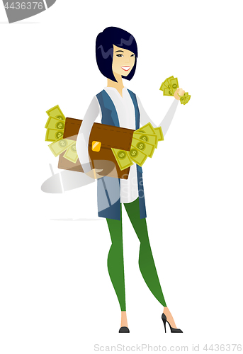 Image of Business woman with briefcase full of money.