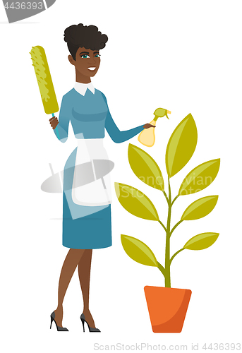 Image of African housemaid watering the flower with spray.