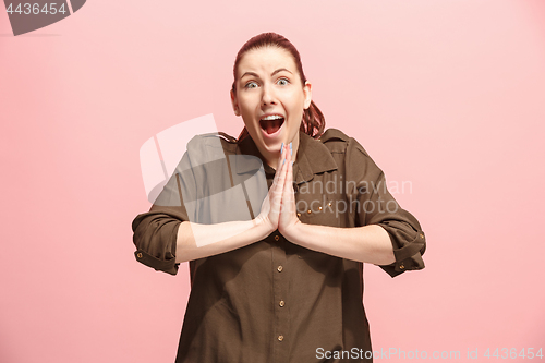 Image of Beautiful woman looking suprised isolated on pink