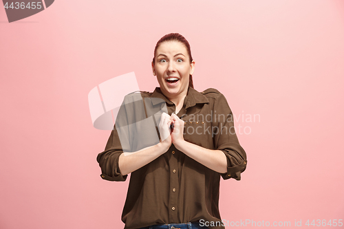 Image of Beautiful woman looking suprised isolated on pink