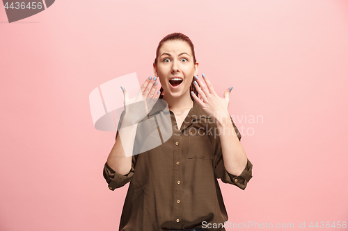 Image of Beautiful woman looking suprised isolated on pink