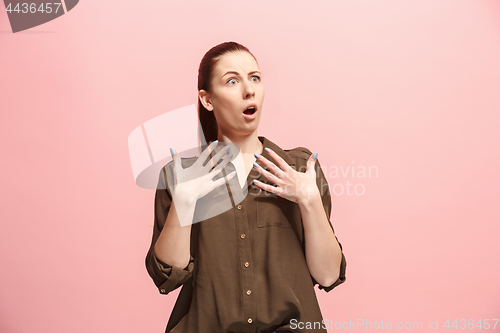 Image of Beautiful woman looking suprised isolated on pink