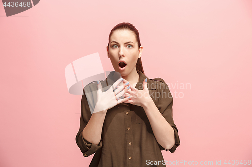 Image of Beautiful woman looking suprised isolated on pink