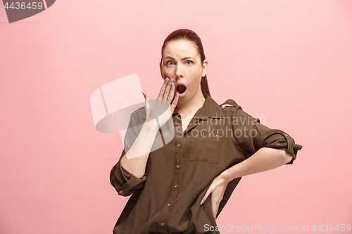 Image of Beautiful woman looking suprised isolated on pink