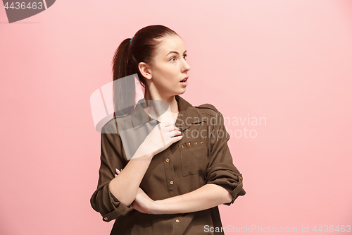 Image of Beautiful woman looking suprised isolated on pink
