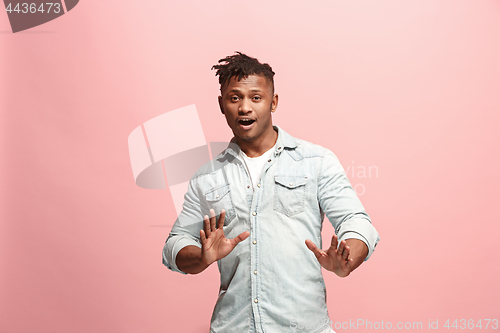 Image of Handsome man looking suprised isolated on pink