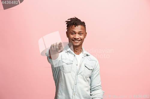 Image of The happy businessman point you and want you, half length closeup portrait on pink background.