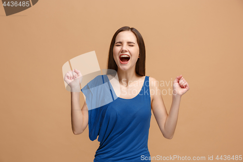 Image of The happy business woman standing and smiling against pastel background.