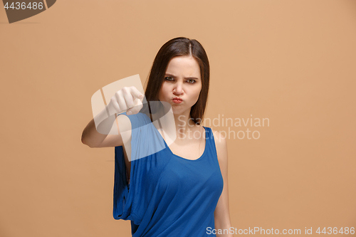 Image of The overbearing woman point you and want you, half length closeup portrait on pastel background.