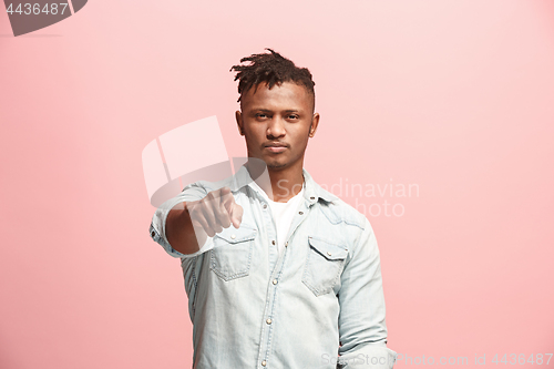 Image of The overbearing businessman point you and want you, half length closeup portrait on pink background.