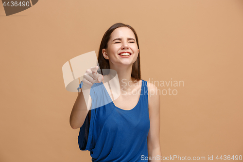 Image of The happy woman point you and want you, half length closeup portrait on pastel background.
