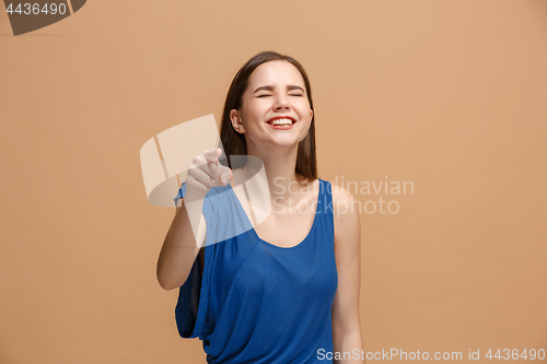 Image of The happy woman point you and want you, half length closeup portrait on pastel background.