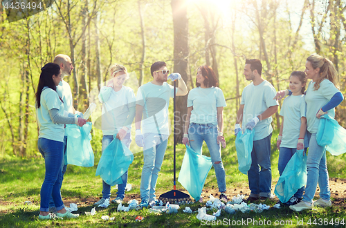 Image of group of volunteers with garbage bags in park