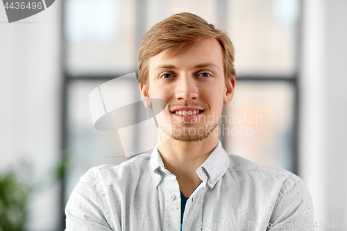 Image of portrait of happy smiling man at office