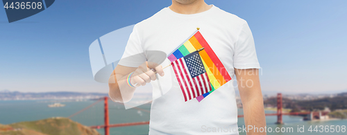 Image of man with gay pride rainbow flag and wristband