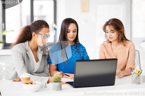 Image of businesswomen with laptop working at office