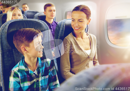 Image of happy mother and son traveling by plane