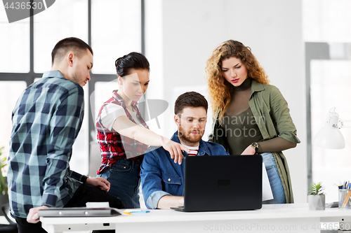 Image of creative team with laptop working at office