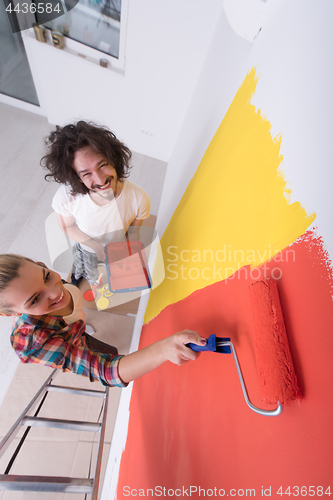 Image of couple painting interior wall