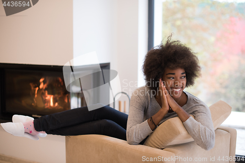 Image of black woman in front of fireplace